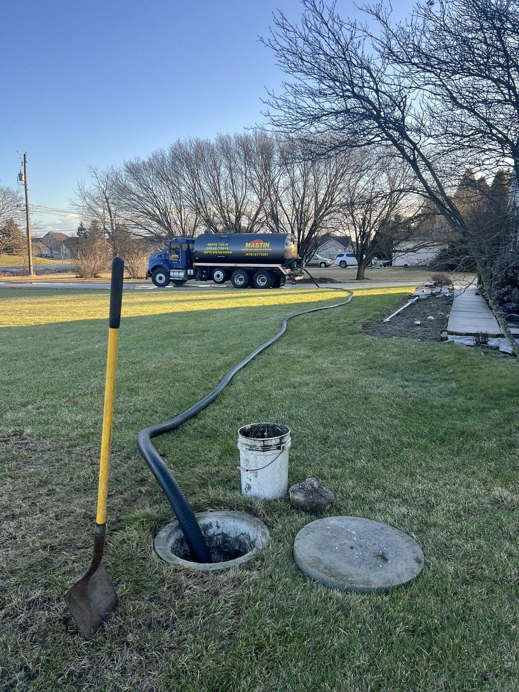 Mastin pump truck servicing a residential septic tank