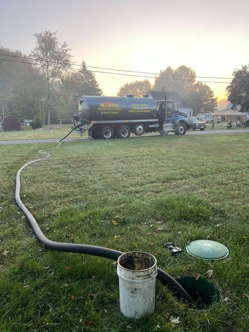 Mastin technician pumping a septic tank in Northwest Ohio