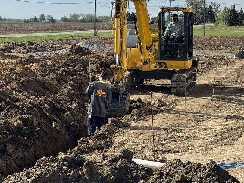 Mastin technician inspecting a septic system installation in progress