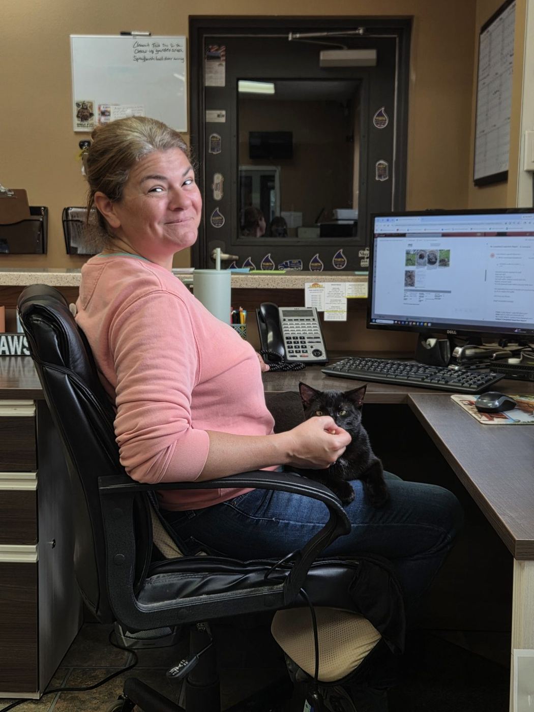 Renae at the Mastin Septic office with Onyx the cat