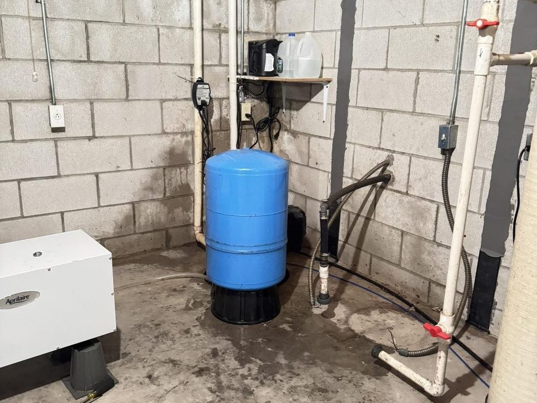 Well water filtration and treatment system in basement