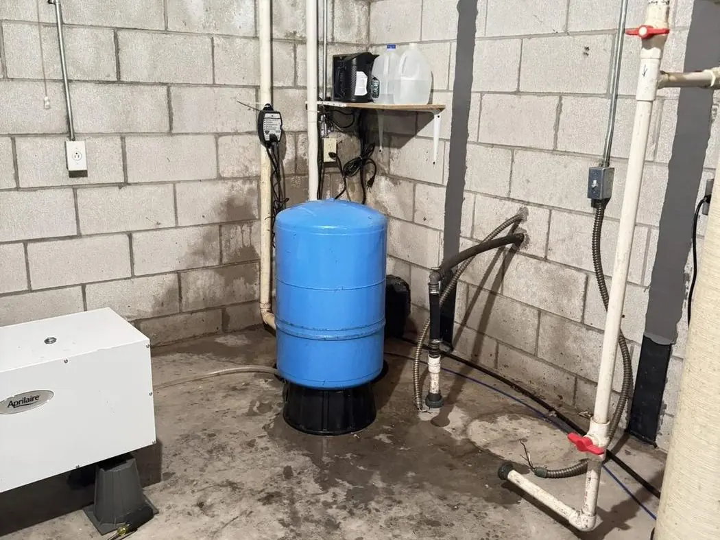Well water filtration and treatment system in basement